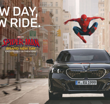Spider-Man leaps above a black BMW driving through New York in a promotional image for Spider-Man: Brand New Day.
