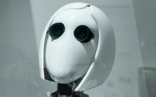 White humanoid robot representing artificial intelligence and automation, used to illustrate how AI is transforming audit work and graduate training.