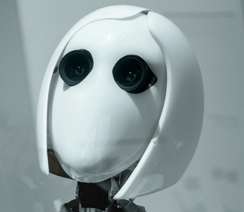 White humanoid robot representing artificial intelligence and automation, used to illustrate how AI is transforming audit work and graduate training.