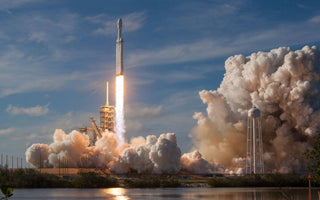 SpaceX rocket launching into the sky with bright flames and thick clouds of smoke surrounding the launch pad, symbolising innovation, ambition and the company’s planned IPO.