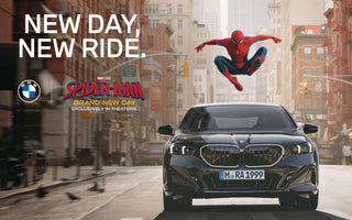 Spider-Man leaps above a black BMW driving through New York in a promotional image for Spider-Man: Brand New Day.