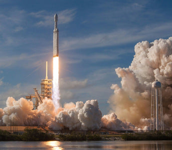 SpaceX rocket launching into the sky with bright flames and thick clouds of smoke surrounding the launch pad, symbolising innovation, ambition and the company’s planned IPO.