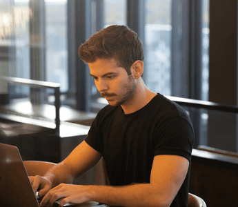 Focused student studying on a laptop in a modern workspace — representing the decision process of choosing the right ACCA professional paper to match strengths and goals.