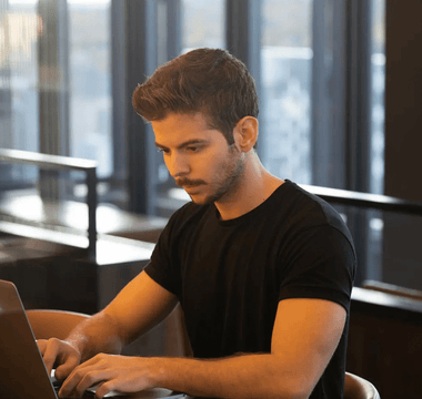 Focused student studying on a laptop in a modern workspace — representing the decision process of choosing the right ACCA professional paper to match strengths and goals.