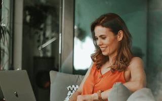 Smiling professional studying online with a laptop — representing learners comparing ACCA, CMA, and CIMA qualifications to choose the best career and salary path.