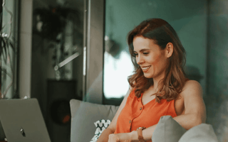 Smiling professional studying online with a laptop — representing learners comparing ACCA, CMA, and CIMA qualifications to choose the best career and salary path.