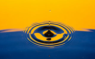 Water droplet ripple effect illustrating drip pricing, where costs gradually increase through hidden fees.