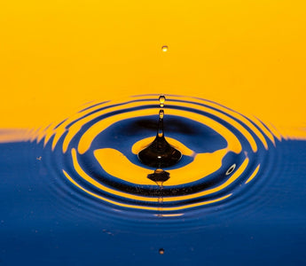 Water droplet ripple effect illustrating drip pricing, where costs gradually increase through hidden fees.