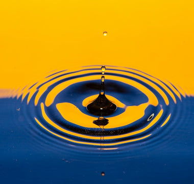 Water droplet ripple effect illustrating drip pricing, where costs gradually increase through hidden fees.