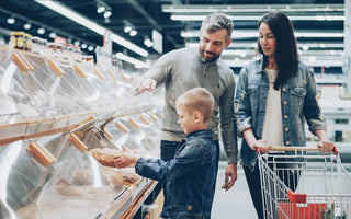 Family shopping for bread in a supermarket, illustrating how store layouts can influence customer buying behaviour.