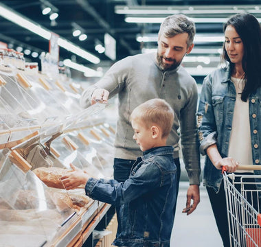 Family shopping for bread in a supermarket, illustrating how store layouts can influence customer buying behaviour.