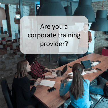 Corporate training session with a presenter leading a team discussion in a modern office, representing ExP’s partnerships with organisations delivering ACCA, CMA, and DipIFR programmes worldwide.