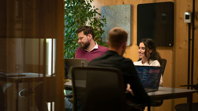 A group of professionals collaborating in a modern meeting room, symbolising universities and industry partners integrating academic and professional qualifications into one seamless pathway.